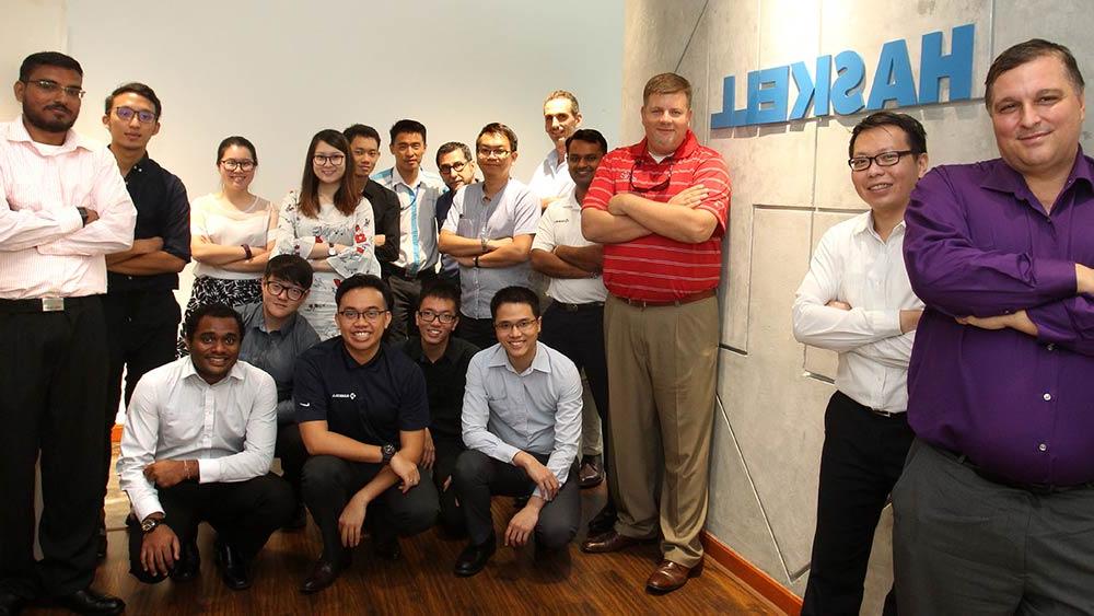 澳门足彩app employees posing with 澳门足彩app signage.